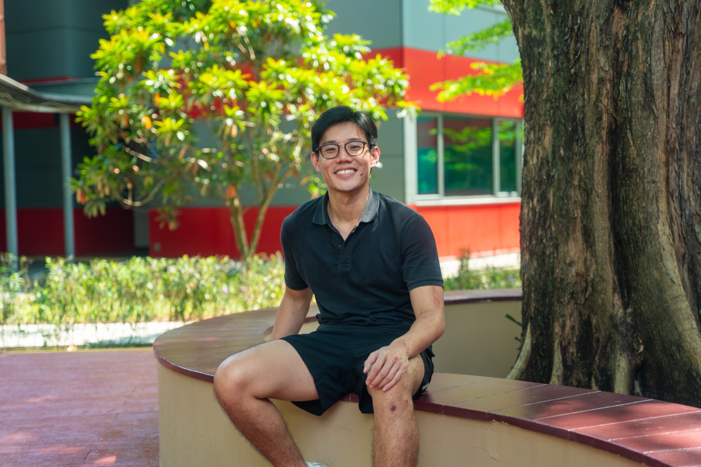 Felix sitting outside on a bench in Singapore